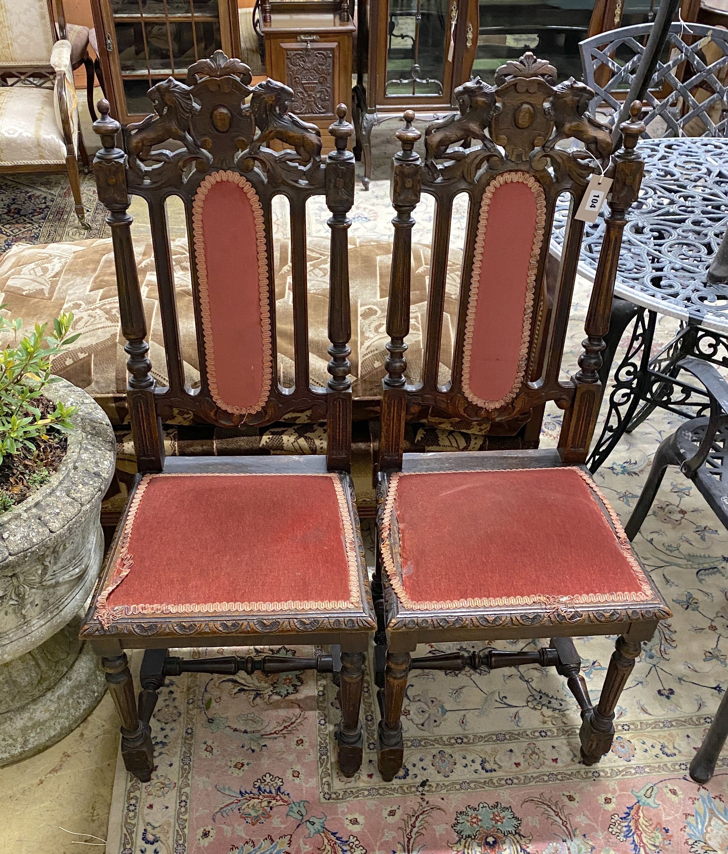 A pair of late Victorian carved oak dining chairs